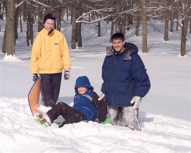 Father and Sons Sledding in Thompson Park.  Credit, Bernie Photos