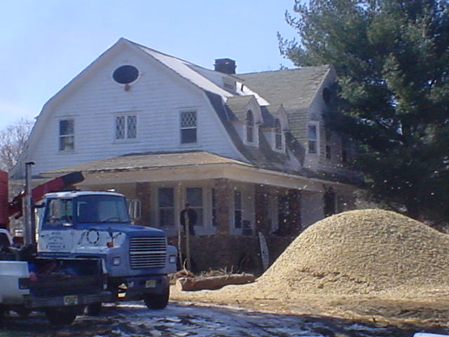 The Mansion awaits demolition.  Note the large pile of woodchips in front of the house.
